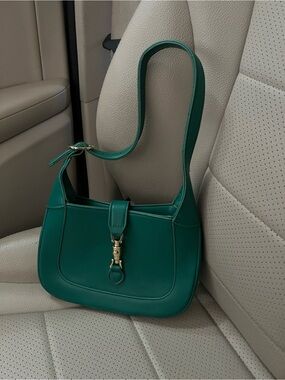 Green faux leather shoulder bag with gold hardware
